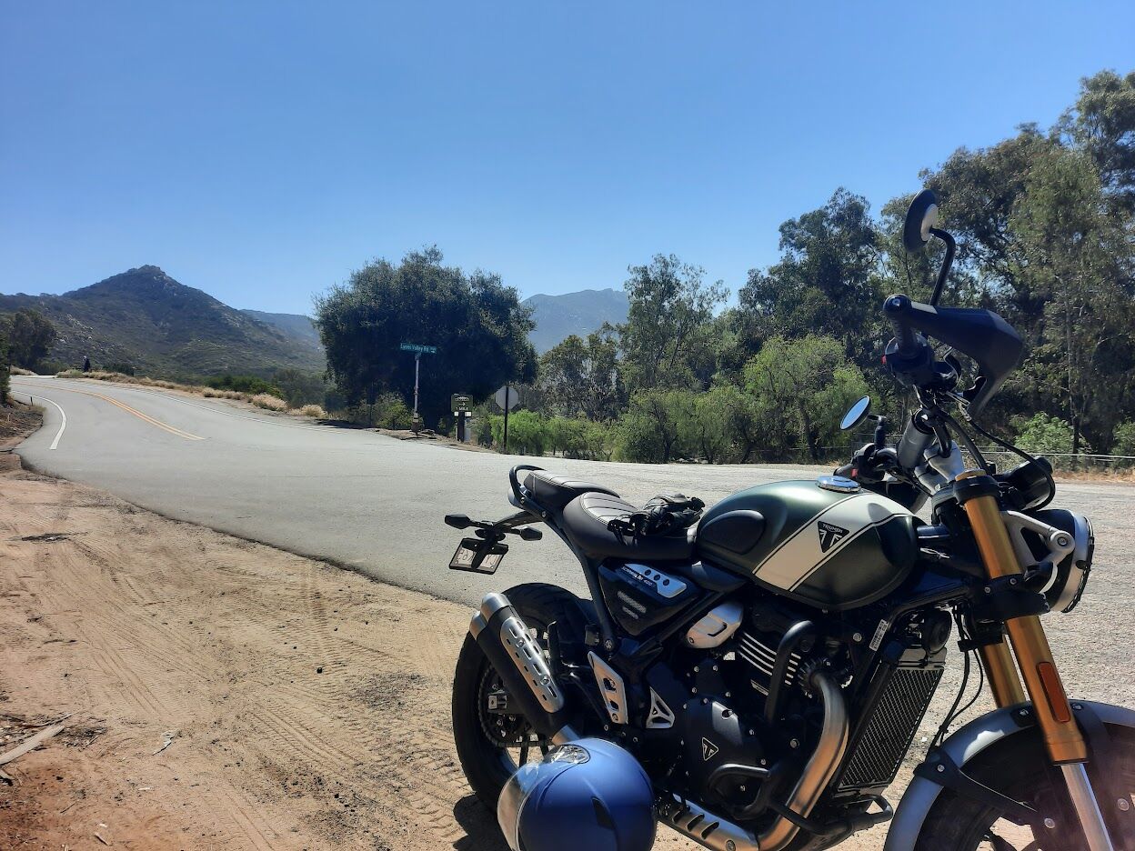Photo of author's bike parked on the side of Lyons Valley Road with hills of East San Diego County in the background