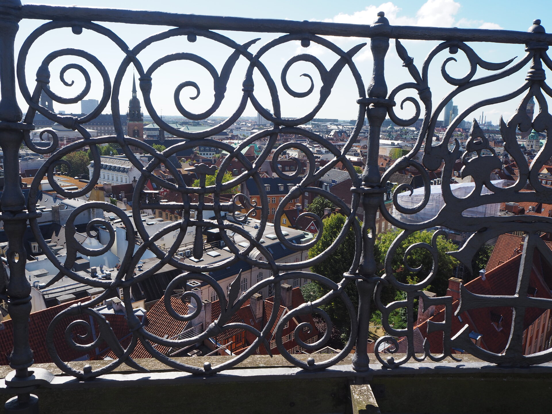 View of Copenhagen skyline with a decorative wrought iron grate in the foreground